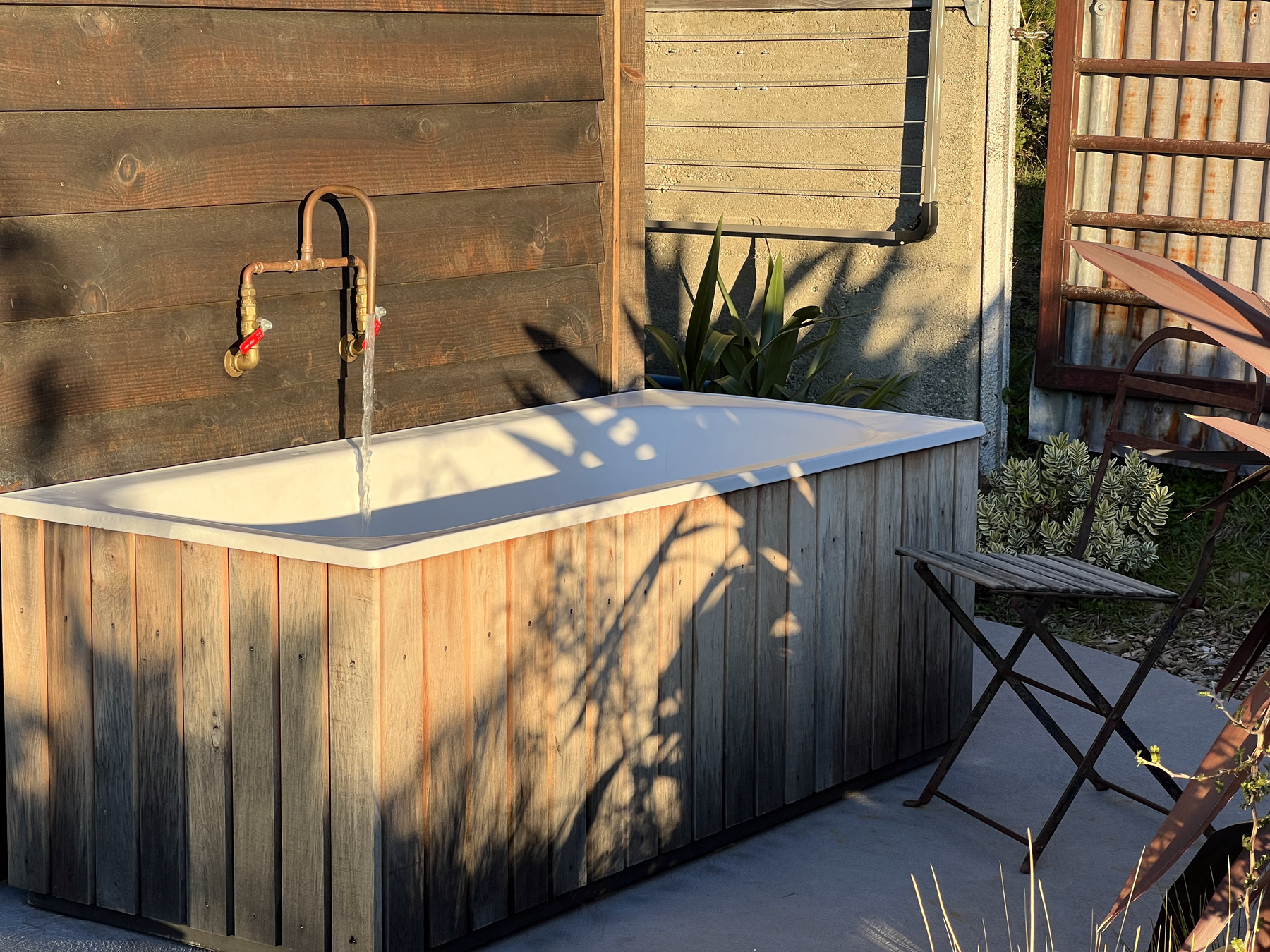 Outdoor wood bath at golden hour