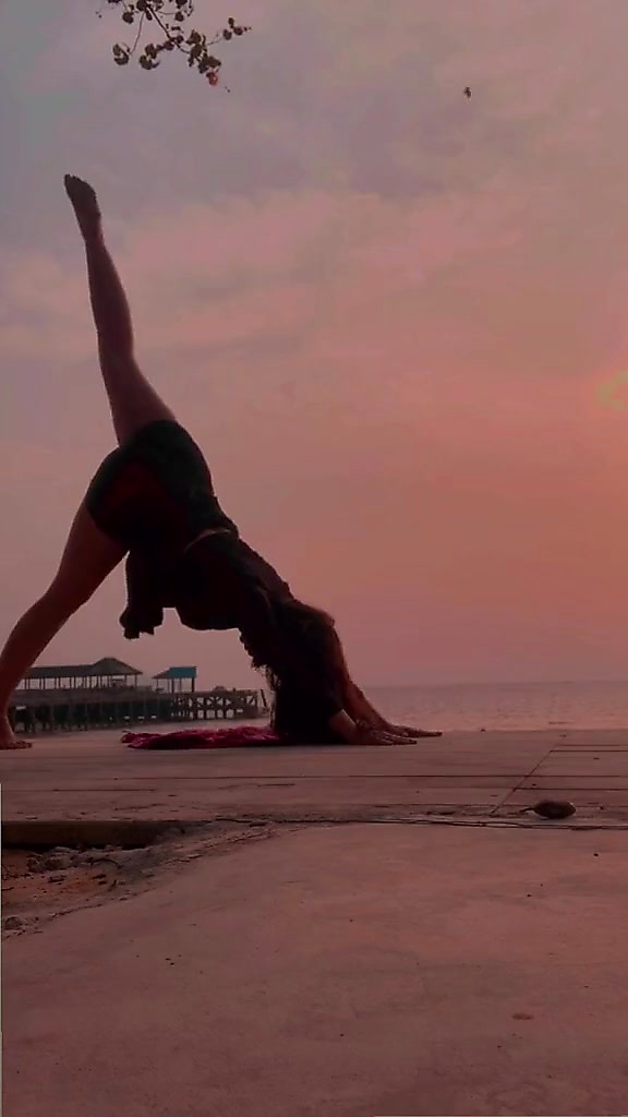 Yoga pose at sunset beach